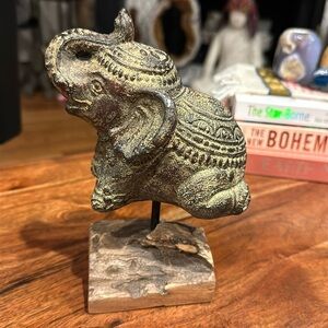 Kneeling Elephant On Wooden Stand